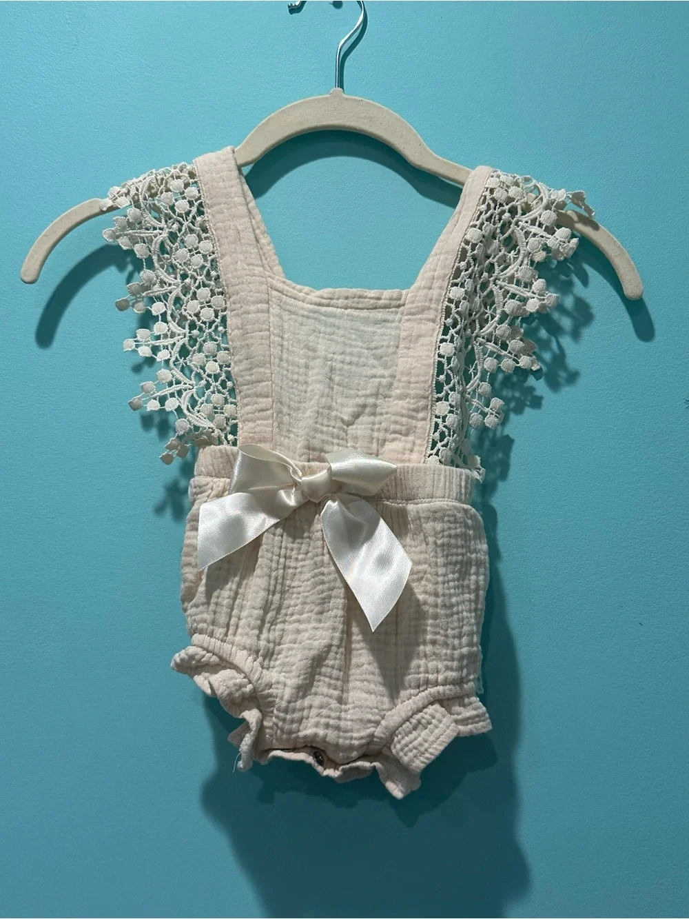 Delicate Cream Baby One-Piece Romper with Lace Straps and Satin Bow